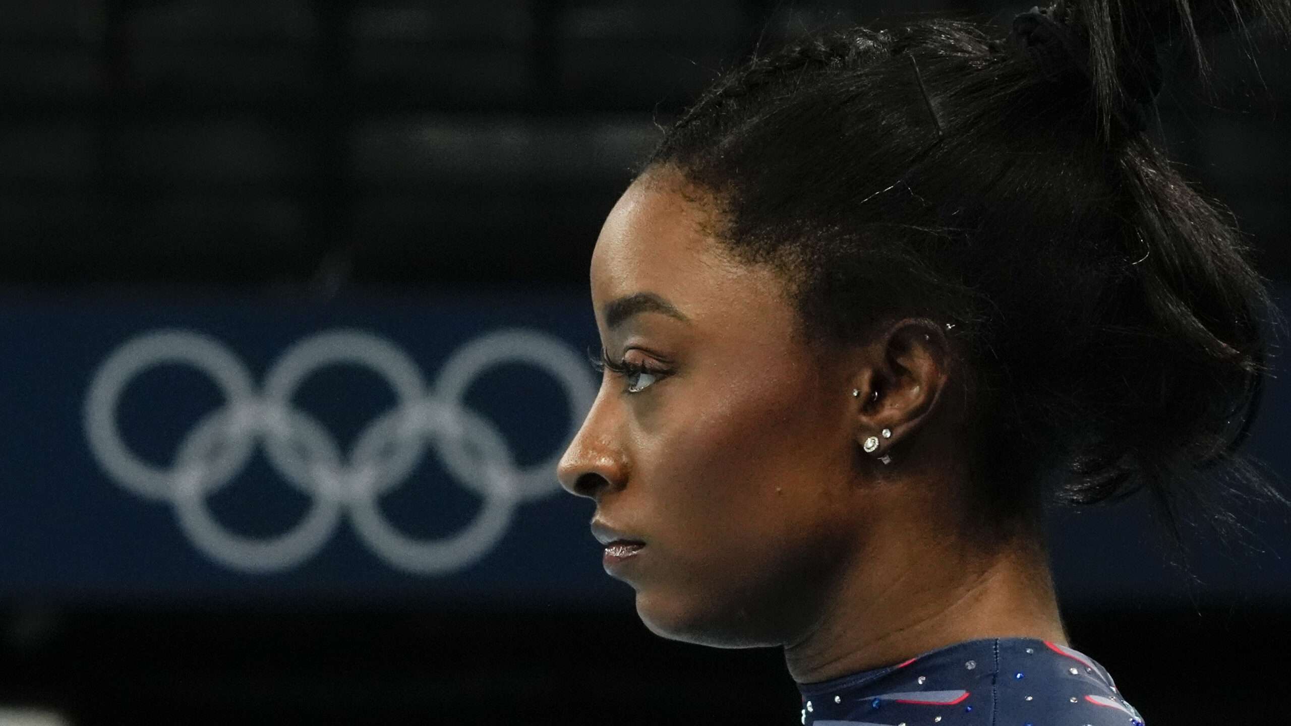 A photograph, on a dark background, of Simone Biles