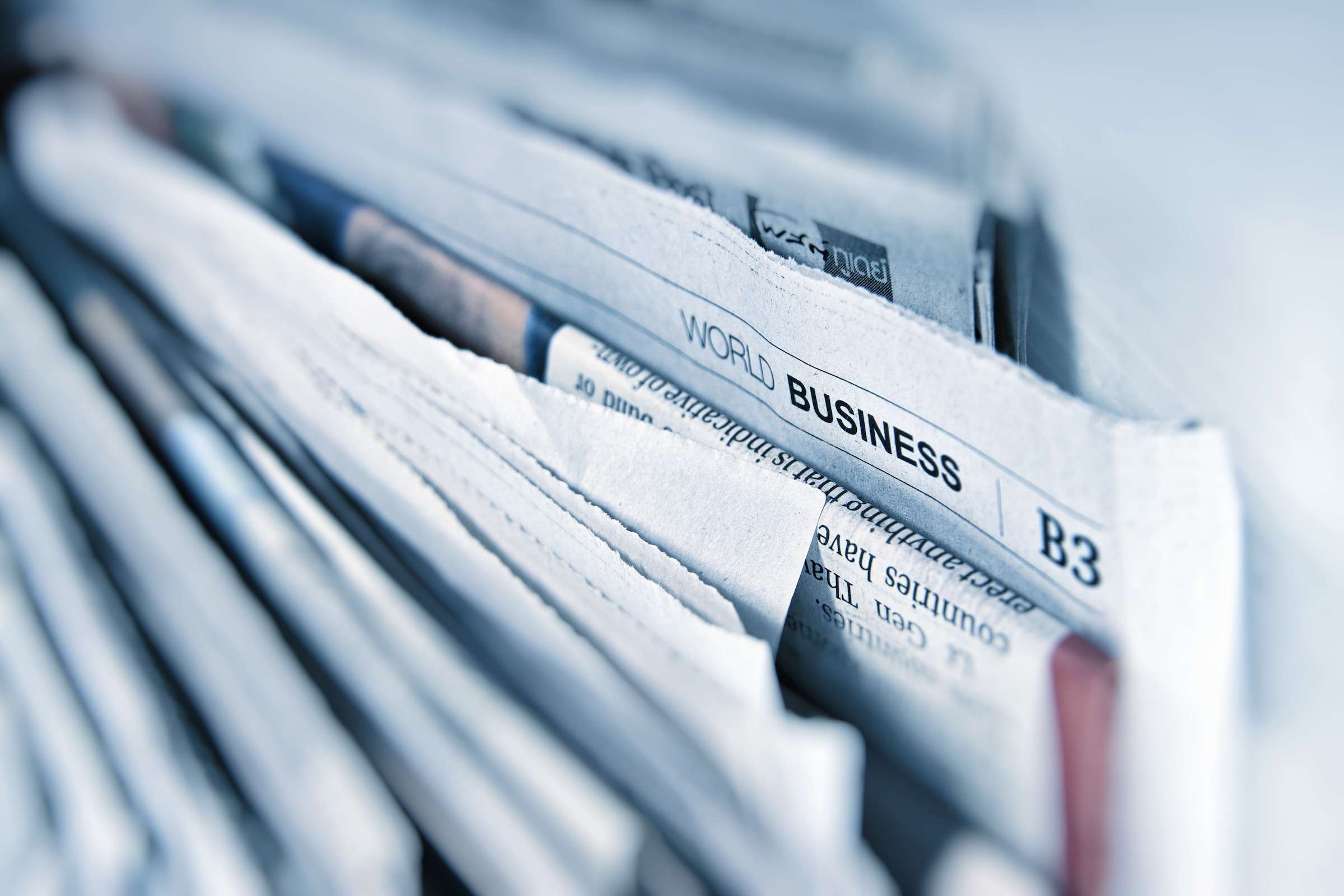 Photograph of newspapers stacked vertically.